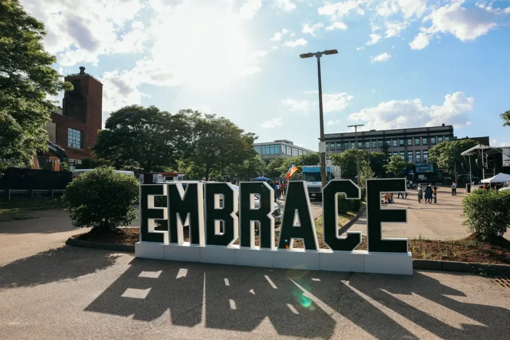 Large outdoor embrace sign.