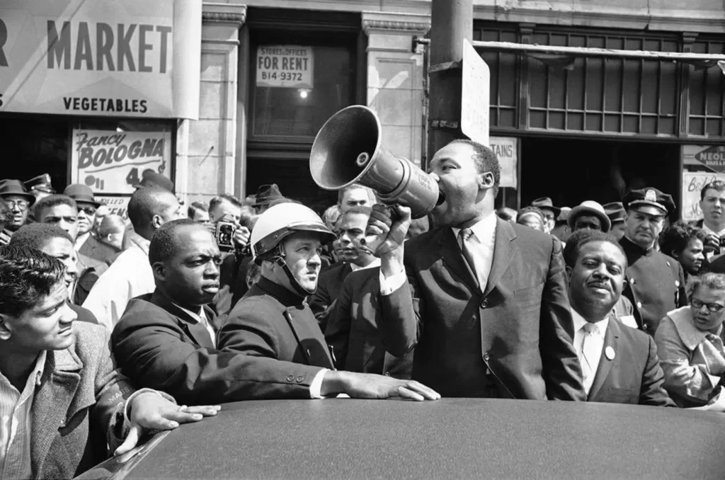 Black and white photo of a crowded speech from Dr. Martin Luther King